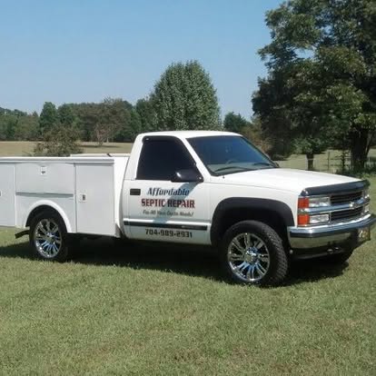 Affordable Septic Repair Chevy work truck in a field