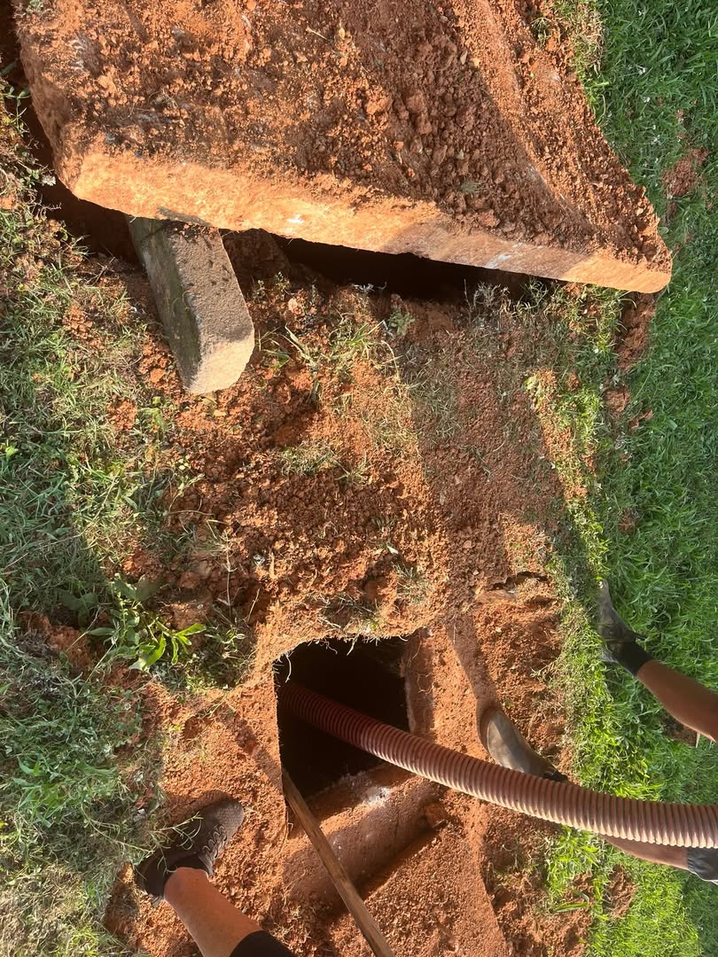 Pumping hose in an open septic tank on a Wingate-area job